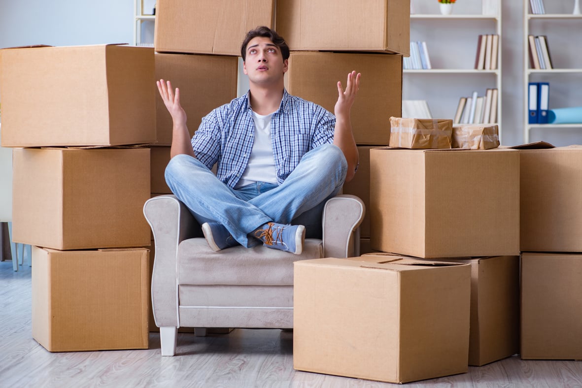 Young Man Moving in to New House with Boxes